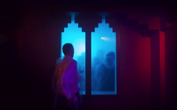  A man looks through a masonic style arched window into the cloud room filled with vaporised gin and tonic. 